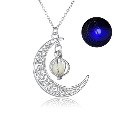 Crescent moon pendant necklace close-up with luminous stone