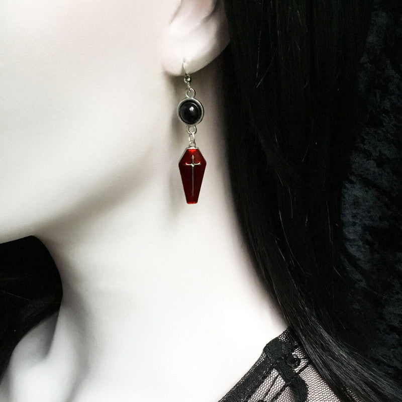 Selected 1 Style crimson coffin cross earring worn on an ear, with a black round setting and silver-tone hook