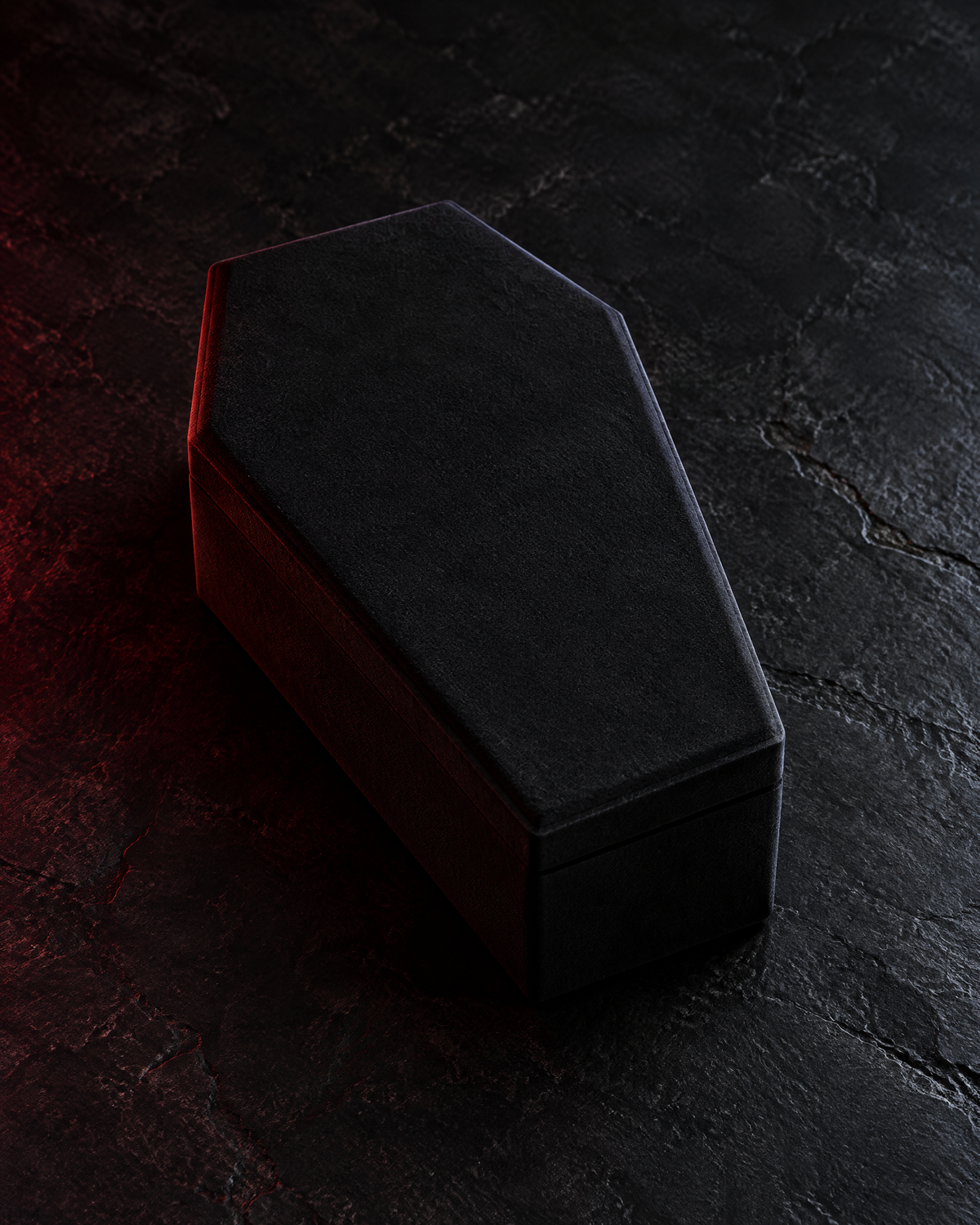 The Reliquary Coffin Jewelry Box in black, shown closed on a dark stone surface.