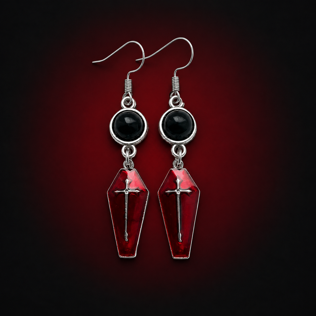Pair of selected 1 Style crimson coffin cross earrings against a dark crimson background