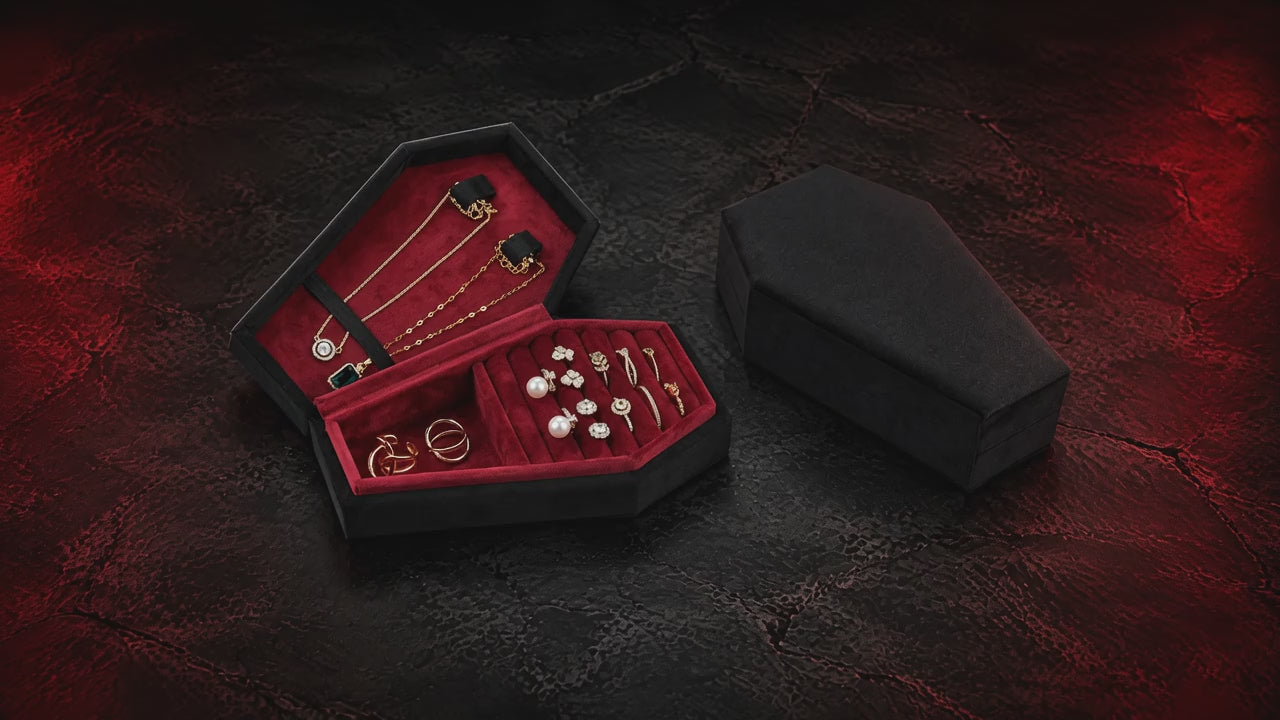Silent slow studio orbit of the open black Reliquary Coffin Jewelry Box with burgundy interior; jewelry shown for illustration and is not included.