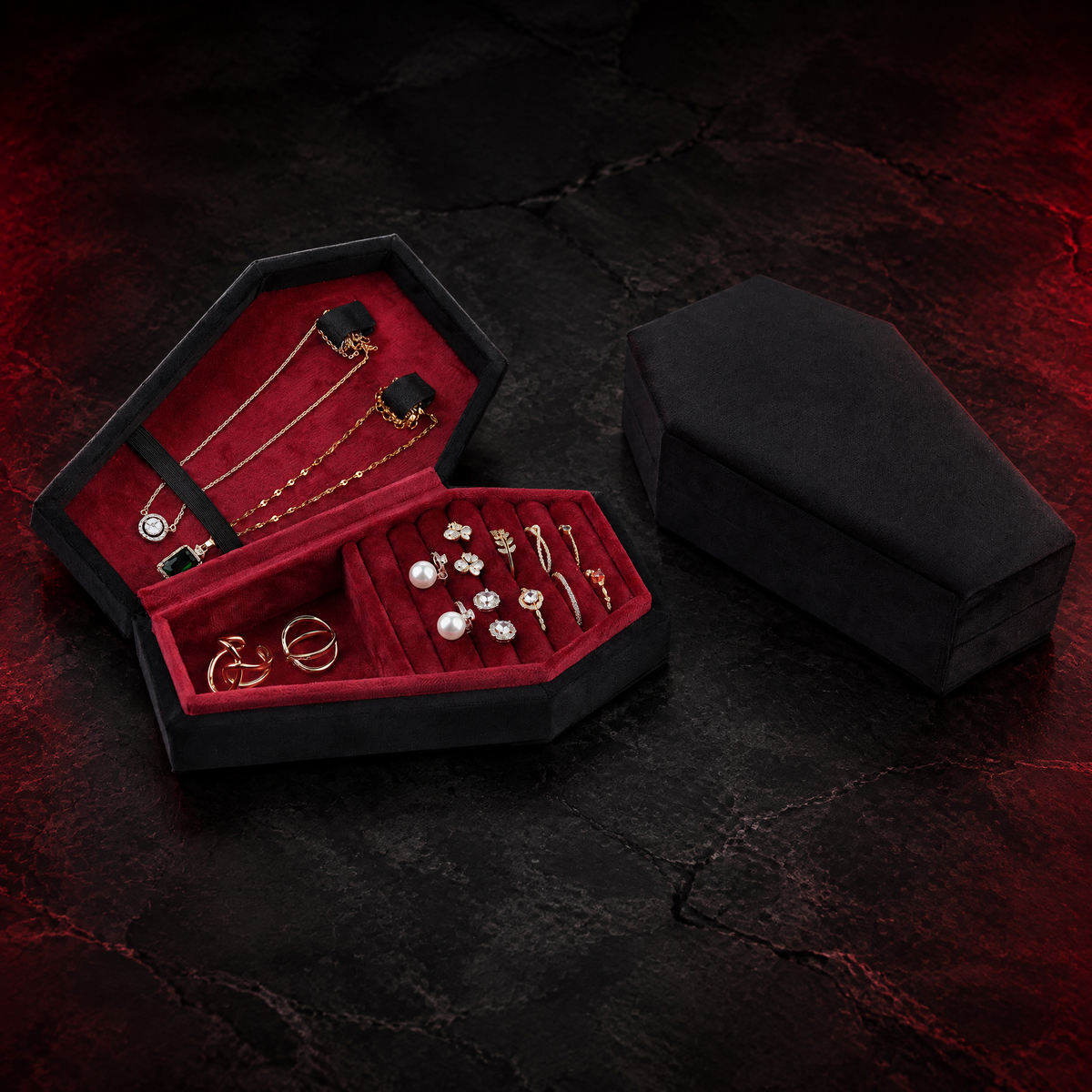 Open black Reliquary Coffin Jewelry Box with burgundy interior against a dark crimson studio background; jewelry shown for illustration and is not included.